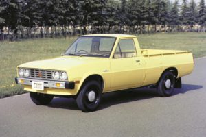 Mitsubishi L200 pickup truck side view yellow